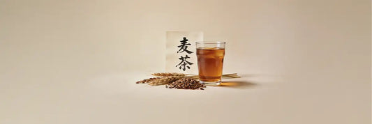 A bowl of mugicha (roasted barley tea) alongside the Japanese kanji characters 麦茶 displayed on traditional packaging.